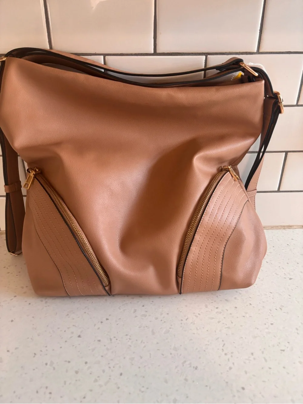 Tan Leatherette Shoulder Bag with Front Zip Pockets. Hand strap or backpack